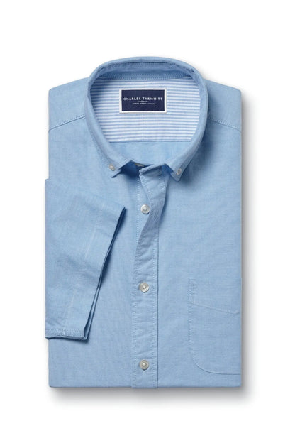 Light blue short-sleeve button-up shirt with chest pocket and button front, flat lay