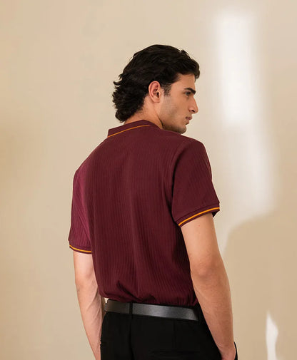 Maroon fitted polo shirt with ribbed knit texture and yellow-trim collar, side view