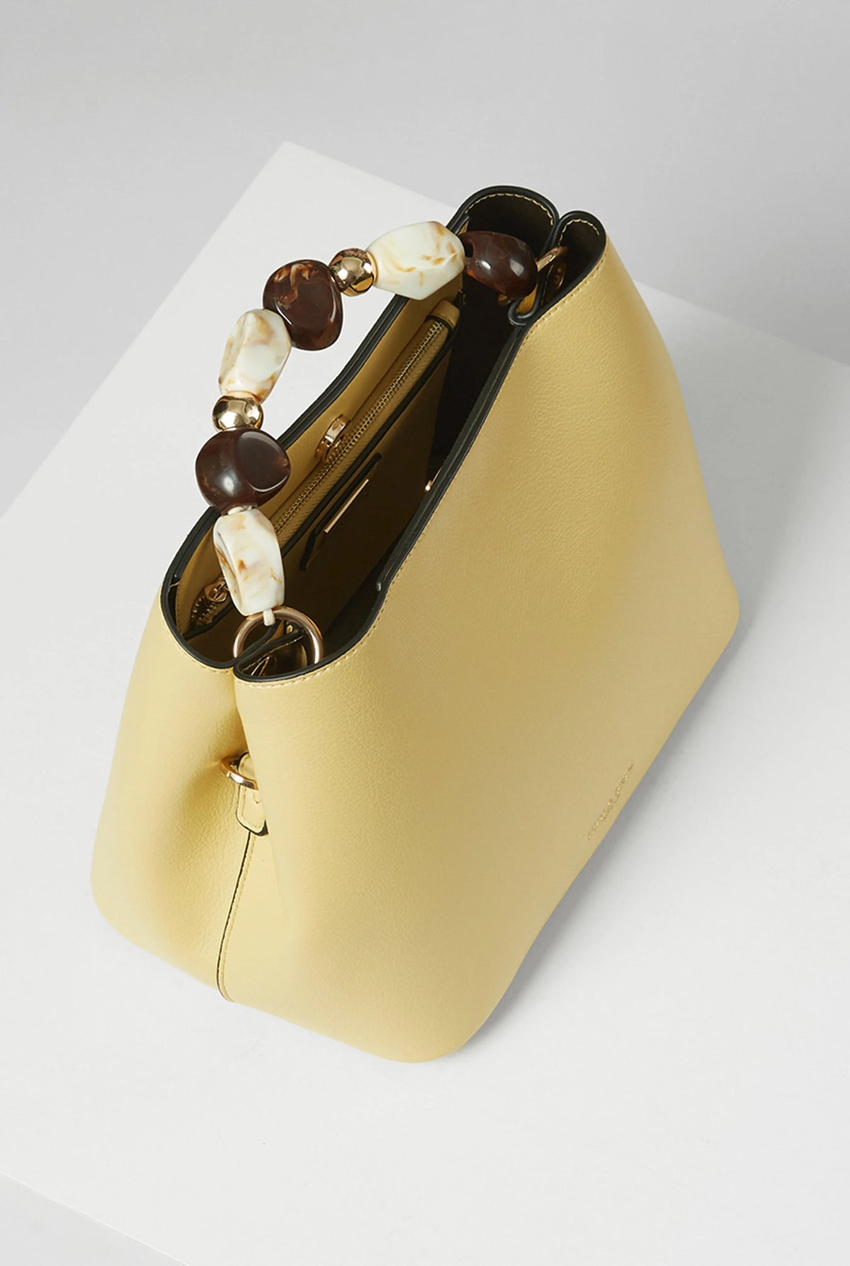 Yellow hobo handbag with beaded tortoiseshell handle detail and wide curved body