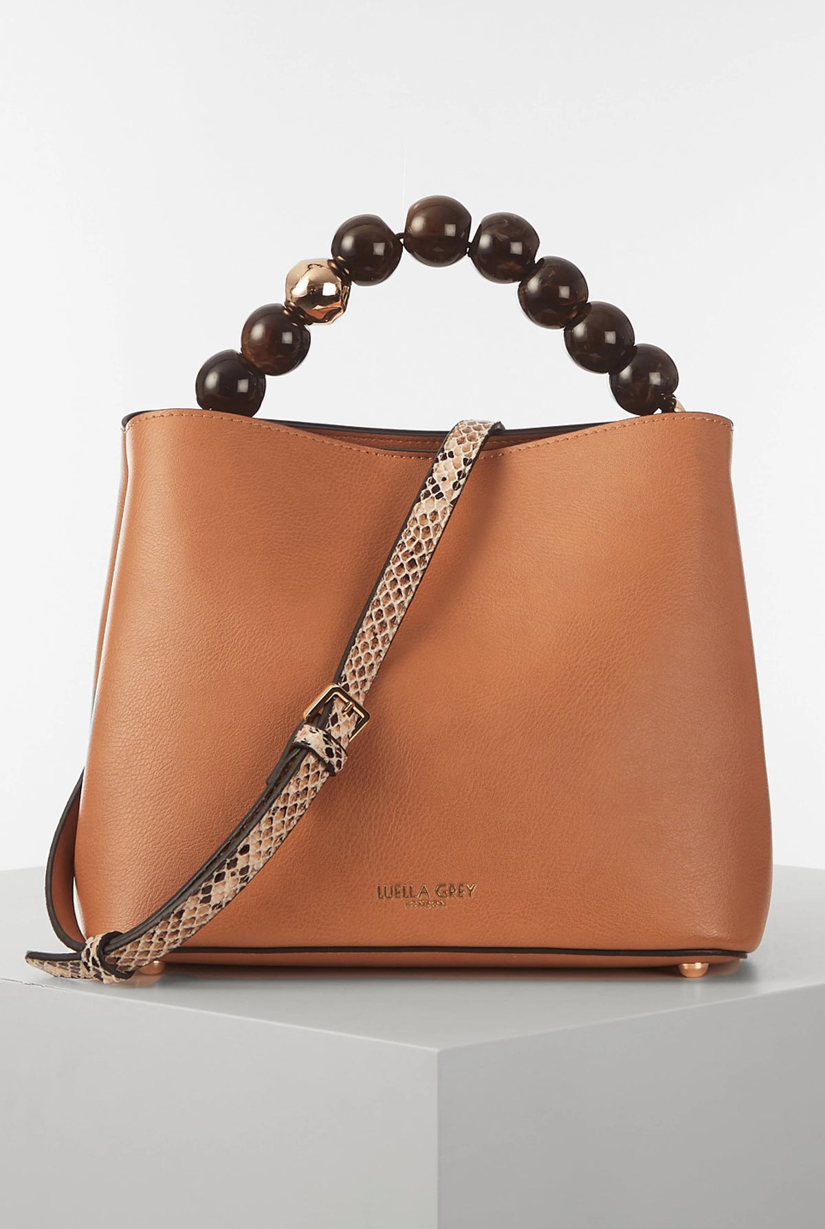 Brown leather bucket handbag with bead handle and leopard-print shoulder strap