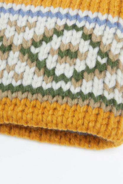 Striped knit headband close-up with textured yarn in mustard, cream, blue, and green