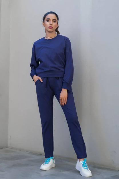 Navy crewneck sweatshirt with drawstring joggers, cuffed sleeves, relaxed fit