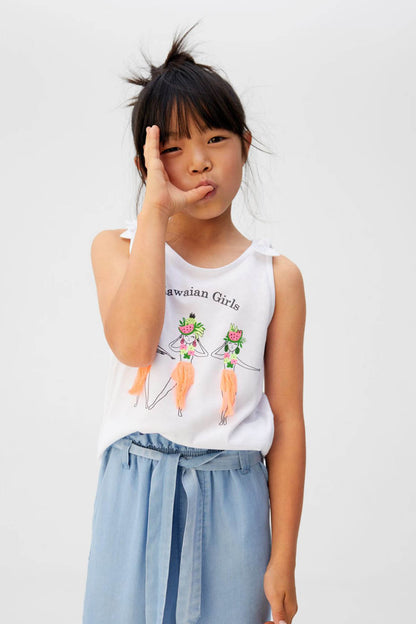Off-white girls' sleeveless tank top with ruffled shoulder and 'Hawaiian Girls' graphic