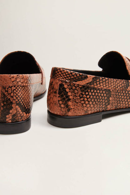Orange-brown snake-print slip-on loafers with rounded back and black sole