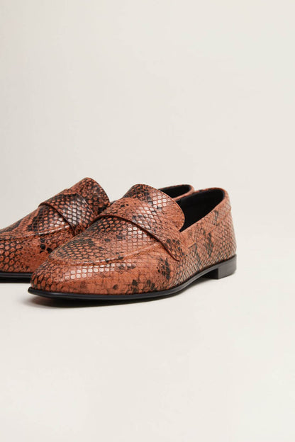 Orange-brown snake-print loafer shoes with bow detail and black sole