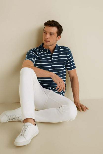 Men's dark navy striped polo shirt, worn by model seated