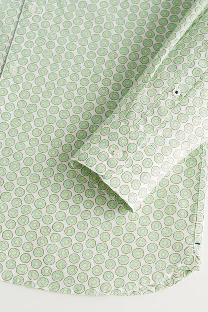 Close-up of green patterned shirt fabric with button placket and collar