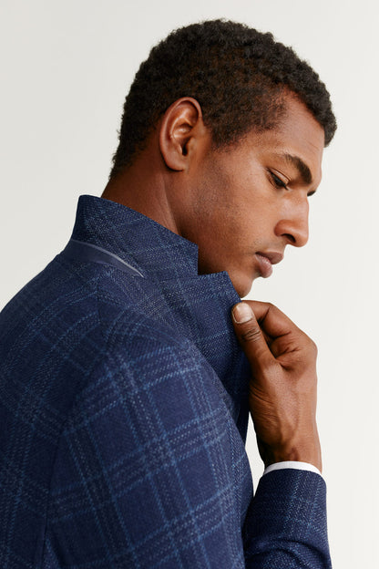 Blue plaid blazer collar close-up with notch lapel and buttoned cuff