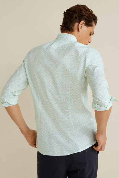 Light green patterned button-up shirt, back view with rolled sleeves and cuffs