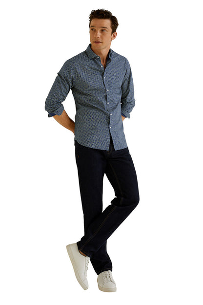 Men's dark navy patterned button-up shirt with long sleeves, worn with dark jeans