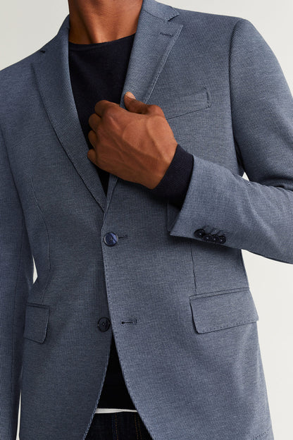 MANGO blue blazer close-up: notch lapel, button front, flap pockets