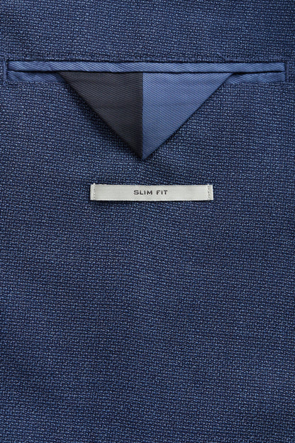 Blue slim fit blazer close-up with inner triangular lining and SLIM FIT label
