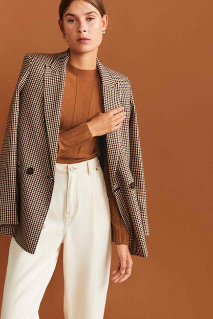 Caramel ribbed knit crew-neck sweater worn under check blazer