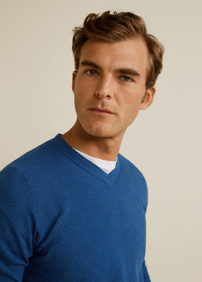 Indigo blue V-neck sweater close-up with soft knit texture