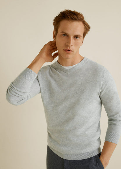 Light heather grey crewneck knit sweater with long sleeves and ribbed cuffs