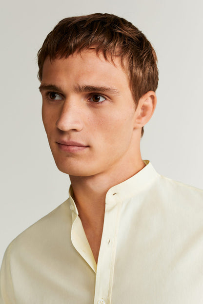 Men's yellow shirt close-up with band collar and button placket