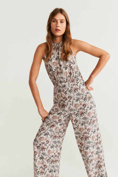 Off-white floral sleeveless jumpsuit with wide legs, high neck, and gathered waist