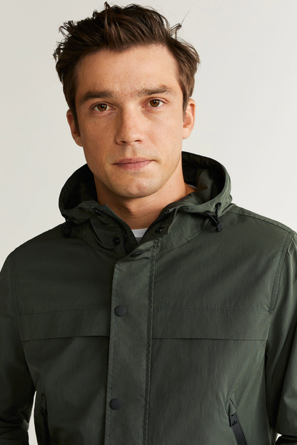 Men's dark khaki hooded jacket close-up with button front and chest pocket
