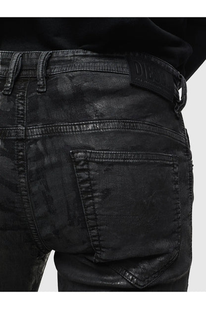 Black distressed jeans close-up of back pocket with stitched yoke detail