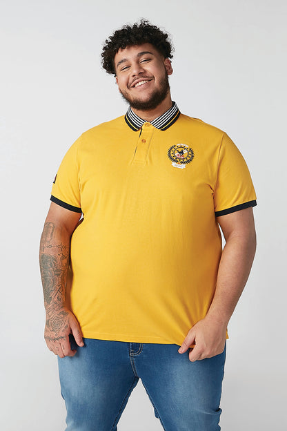 Men's yellow polo shirt with striped collar and chest crest logo