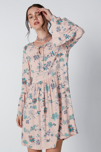 Pink floral long-sleeve mini dress with tie-neck detail and gathered waist