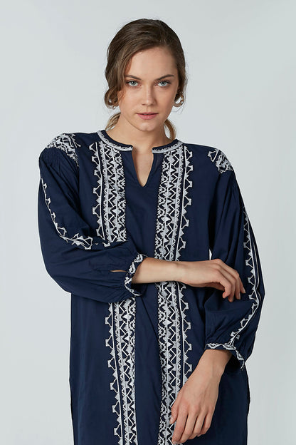 Navy long-sleeve dress with white vertical embroidered stripes at neckline