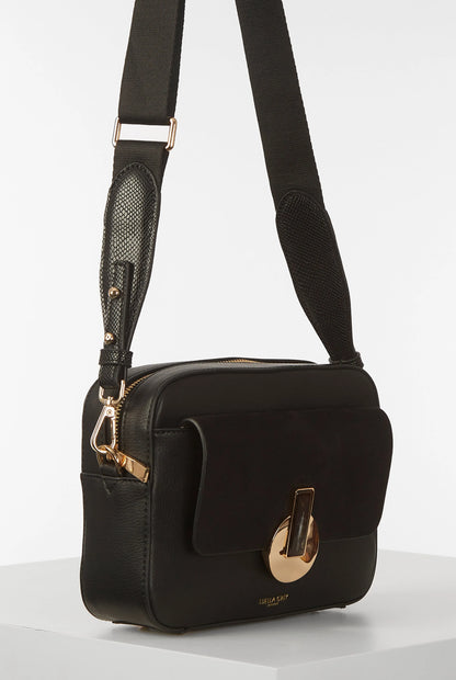 Black small shoulder bag with adjustable strap, front flap, and gold hardware