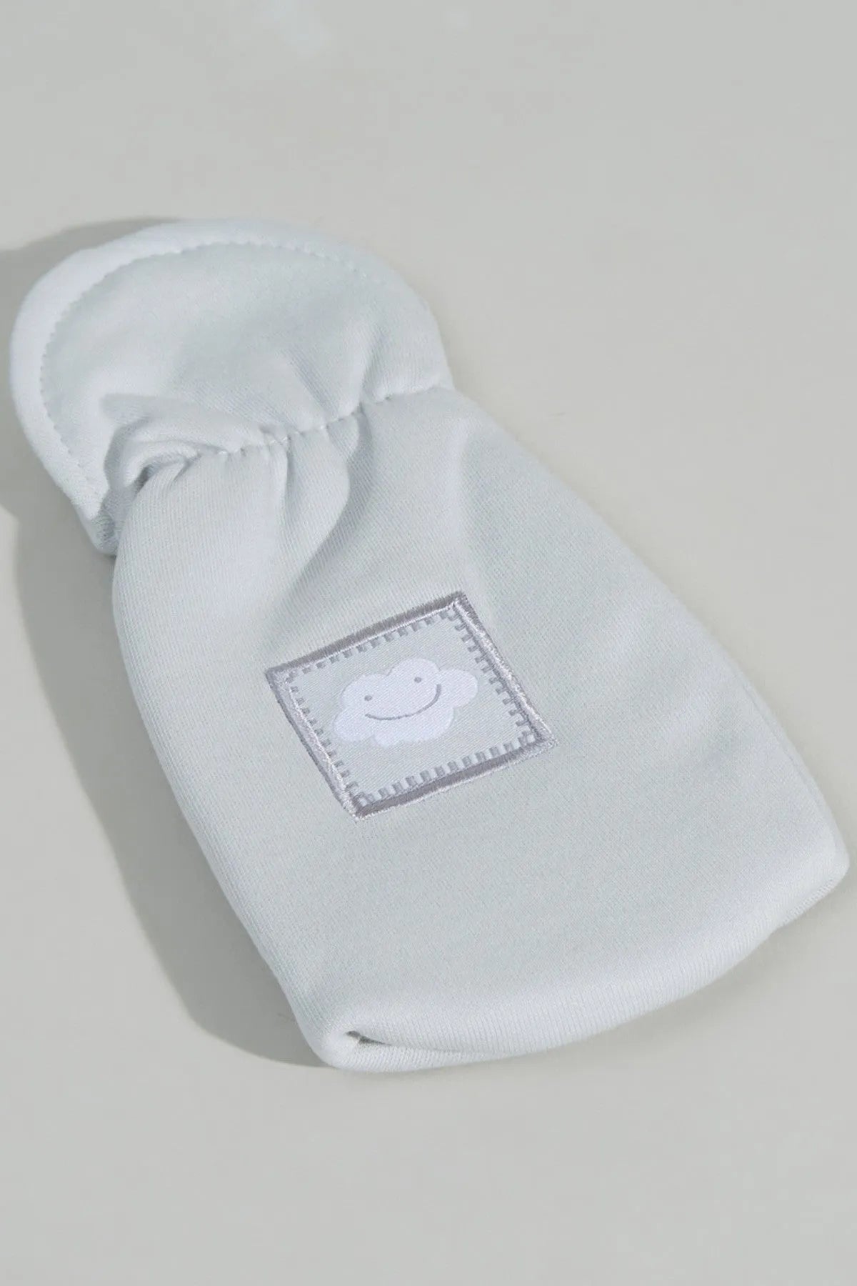 Light blue baby hooded pouch with smiling cloud patch