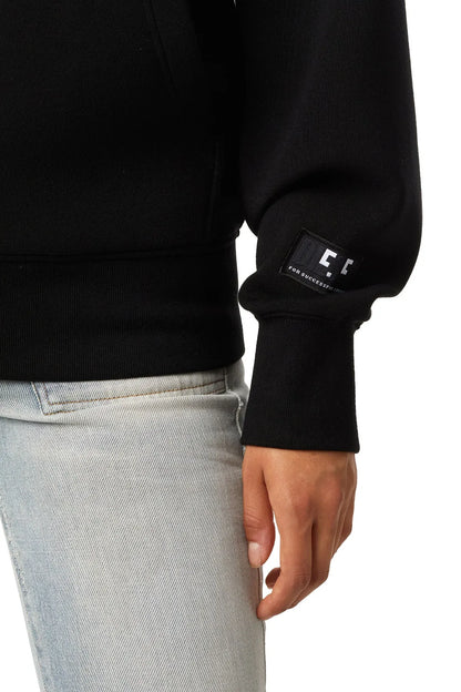 Black hoodie sleeve with branded rubber patch on cuff