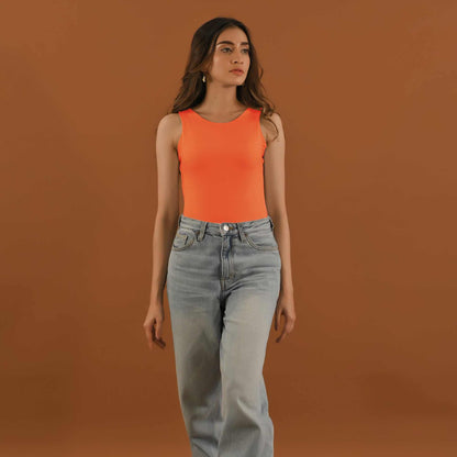Thread orange sleeveless tank top with light-wash straight jeans, front view
