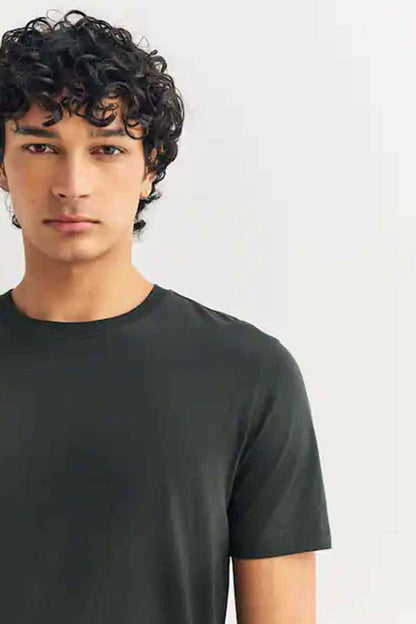 Olive green crewneck short-sleeve T-shirt, close-up neckline and shoulder