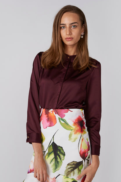 Burgundy long-sleeve blouse and floral knee-length skirt, front view