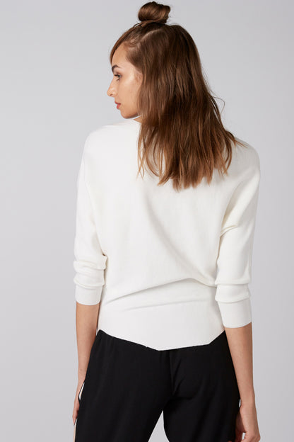 White crewneck top with small embellishments, three-quarter sleeves