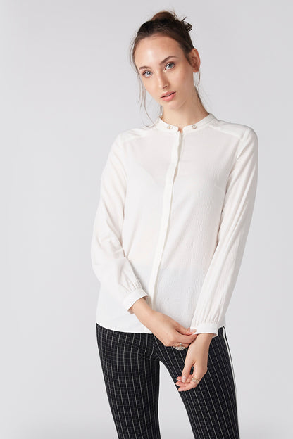 White button-front blouse with stand collar and long sleeves