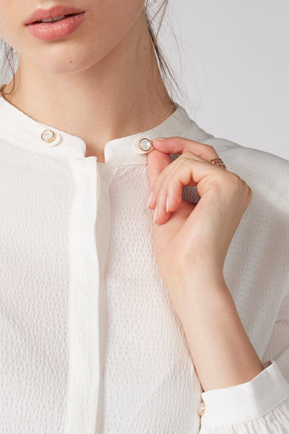 White blouse collar with button placket and round metal buttons detail