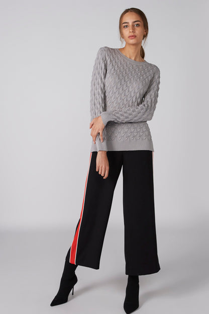 Grey textured knit sweater with crew neck and long sleeves, ribbed hem