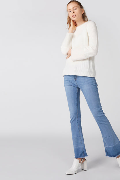 White knit crewneck sweater with long sleeves and ribbed cuffs, full-body view