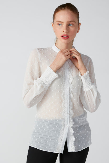 White dotted zip-front jacket with stand collar and long buttoned cuffs
