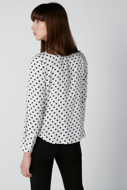 White polka-dot blouse back view with long sleeves