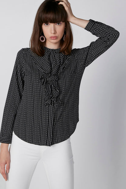 Black and white dot-pattern blouse with tie-front and long sleeves