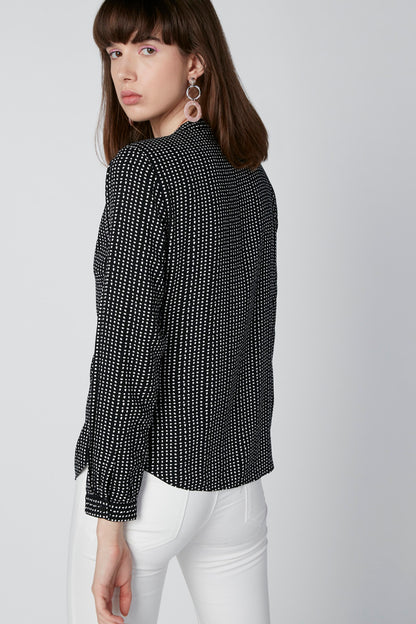 Black and white dot-pattern blouse with tie-front and long sleeves