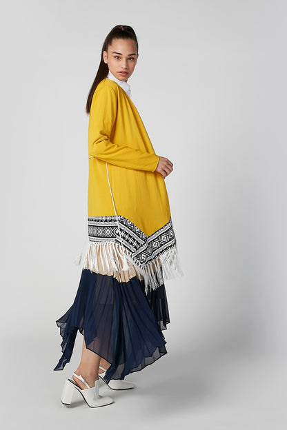 Yellow boho dress with patterned fringe hem and tiered navy skirt, side view