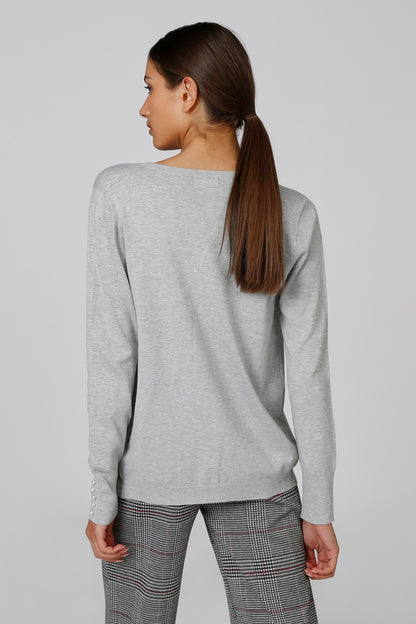 Light gray long-sleeve cardigan showing the back and button-front hem.
