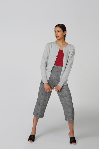 Light gray button-front cardigan with long sleeves, worn open over a red top.