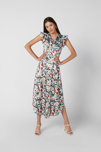 Women's sleeveless midi dress with tiered hem and teal coral scroll print, standing pose.