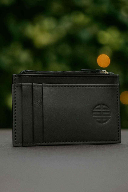 Black leather card holder with multiple card slots and embossed emblem