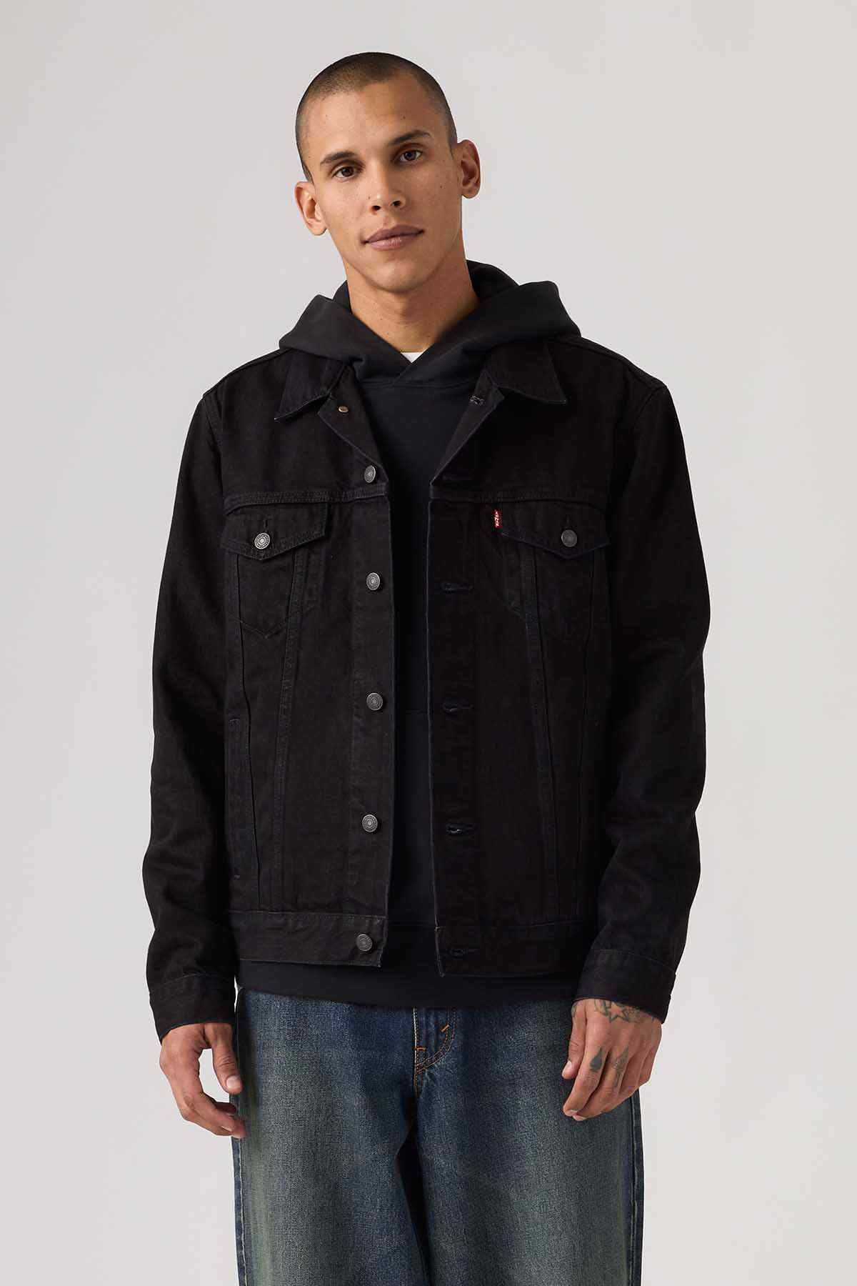 Black denim jacket with button front and two flap chest pockets, hood visible