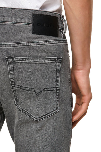 Light gray denim jeans with Diesel logo patch on waistband and stitched front pocket