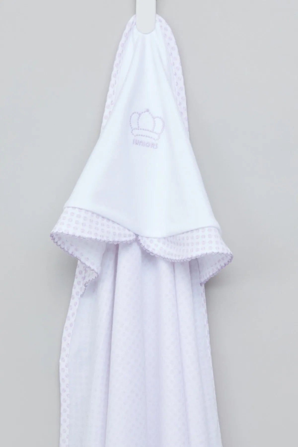White hooded towel with small logo, lace trim, and ruffled hem