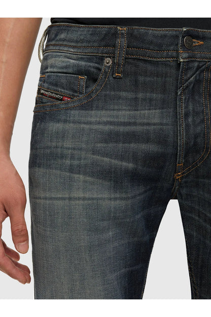 Dark blue denim jeans with coin pocket, belt loops, and contrast orange stitching